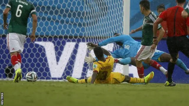 Mexico striker Oribe Peralta (second right) slots in to score for his side against Cameroon