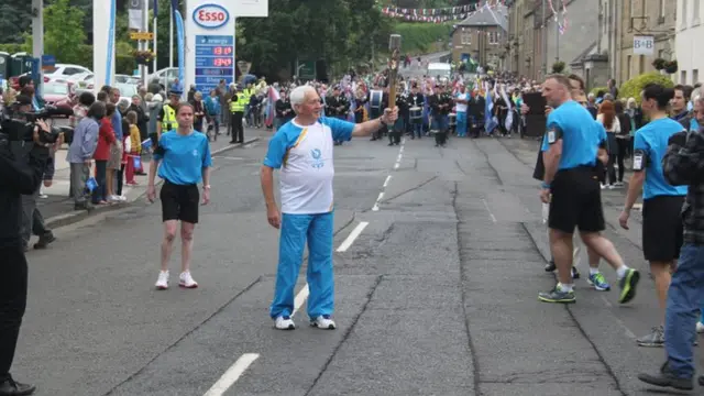 Man holds baton in Coldstream