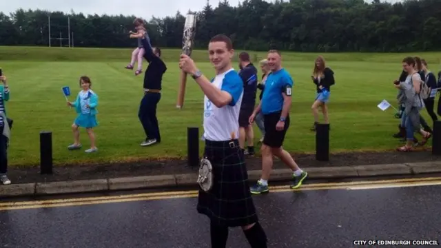 Cameron Finlayson carries baton