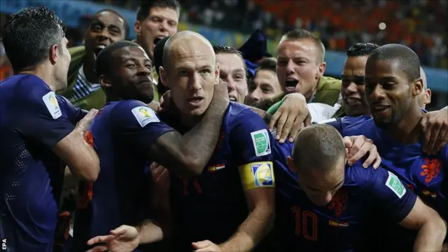 Arjen Robben is mobbed after scoring for Netherlands