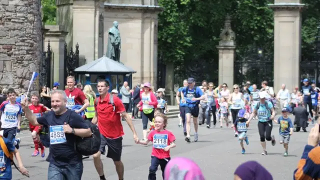 Local school children take part in a fun run from Holyrood Palace to Meadowbank