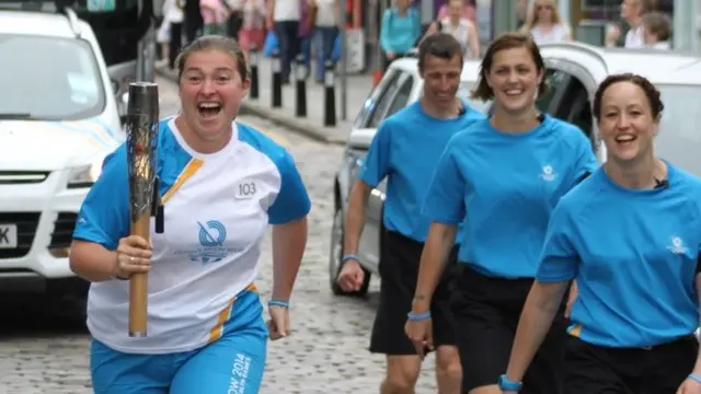 Baton bearer with a big smile on her face