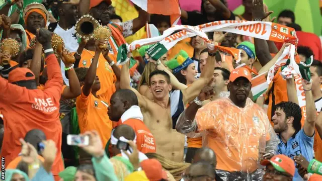 Ivory Coast supporters welcome their side to the pitch