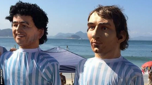 Paper mache models of Diego Maradona and Lionel Messi