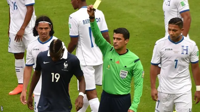 Paul Pogba is shown the yellow card