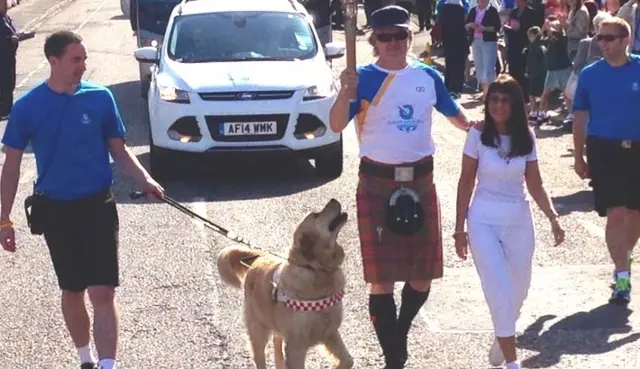 Baton bearer Frankie Thomson is pictured with the baton with his dog Flynn.