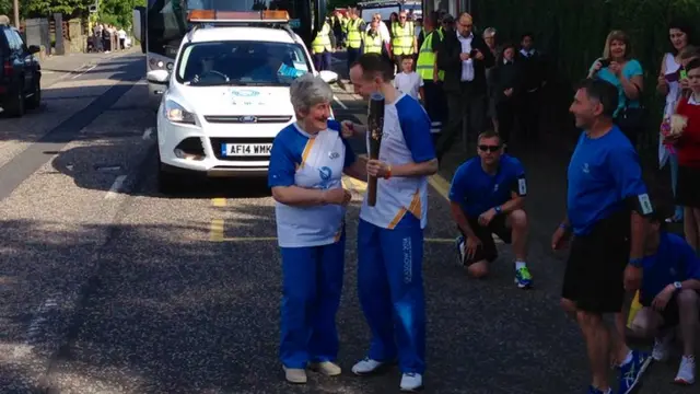 Eleanor Dalgetty is pictured handing the baton to Bryan Findlay