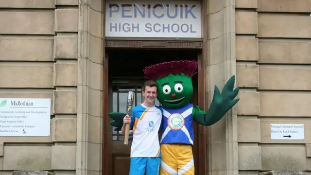 Baton bearer Kieran Fergusson, pictured with Commonwealth Games mascot Clyde at Penicuik High School.