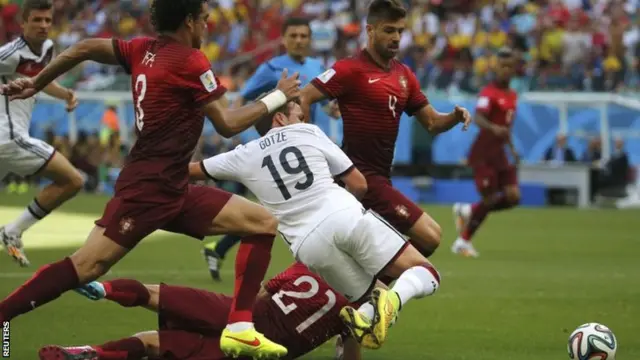 Mario Goetze is fouled after having his shirt pulled by Portugal's Joao Pereira