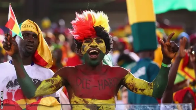 A Ghana fan cheers prior to kick-off