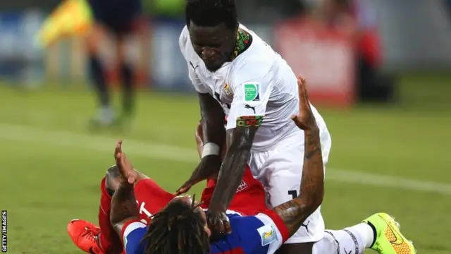 Sulley Muntari of Ghana reacts angrily after a challenge by Jermaine Jones