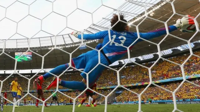 Guillermo Ochoa of Mexico dives to make a save