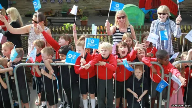 School children welcome the Glasgow 2014 Queen's Baton as it relayed through Duns in the Scottish Borders