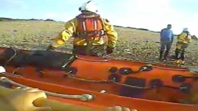 The man talks to the lifeboat crew