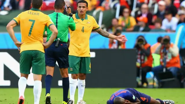 Tim Cahill of Australia is booked for a challenge on Bruno Martins Indi of Netherlands