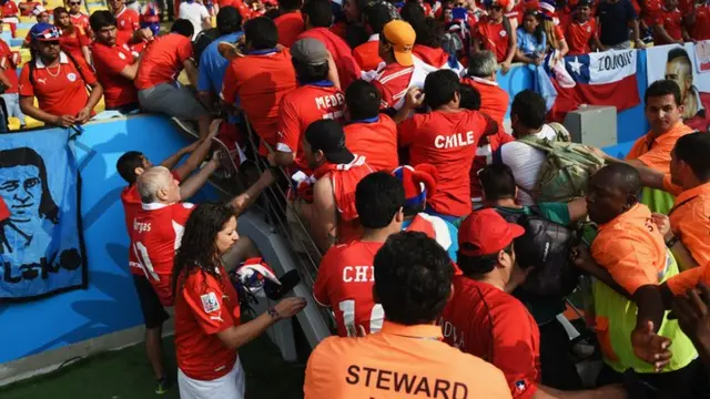 Chile fans pile in for the match against Spain as security try to control the crowd