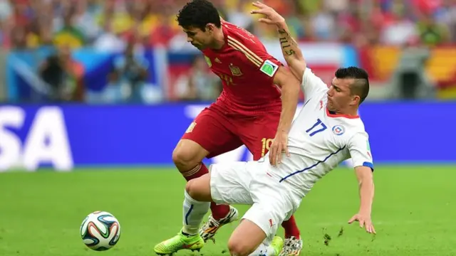 Spain striker Diego Costa is tackled by Chile's Gary Medel