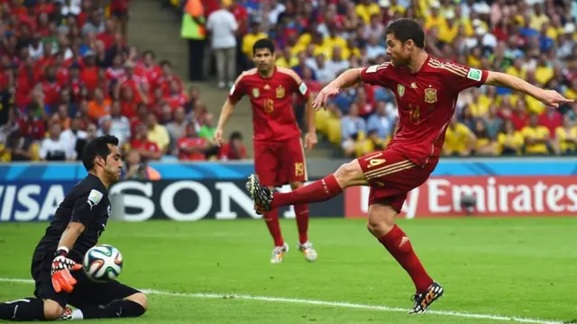 Spain's Xavi Alonso is denied by Chile keeper Claudio Bravo