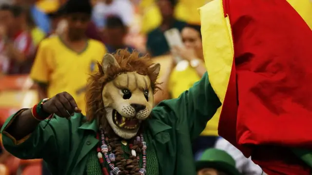 A Cameroon fan dresses up as a lion for the Croatia match