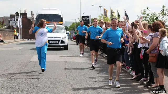 Mairi Gordon carries the Glasgow 2014 Queen's Baton through Dumfries.