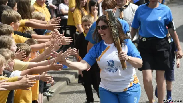 Jennifer Oliver carries the Glasgow 2014 Queen's Baton through Castle Douglas in Dumfries & Galloway.