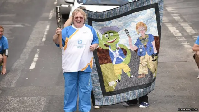 Ann Hill carries the Glasgow 2014 Queen's Baton through Kirkcudbright in Dumfries & Galloway.