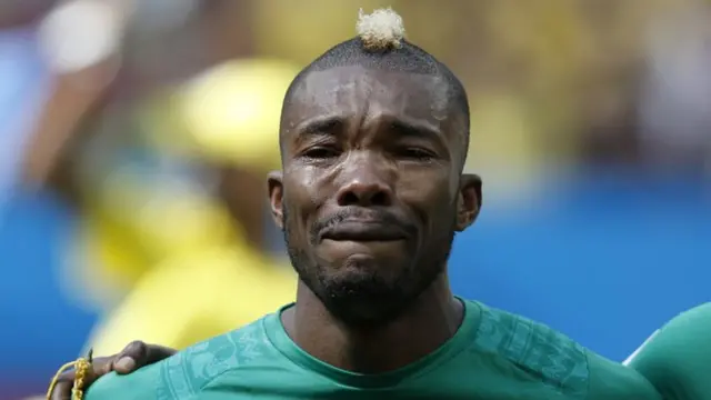 Serey Die of Ivory Coast cries during the national anthem