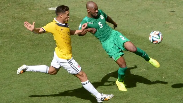 Didier Zokora of Ivory Coast tackles Teofilo Gutierrez