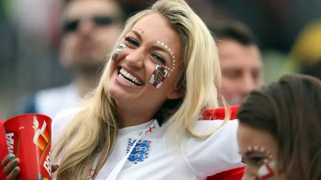 An England fan smiles for the camera