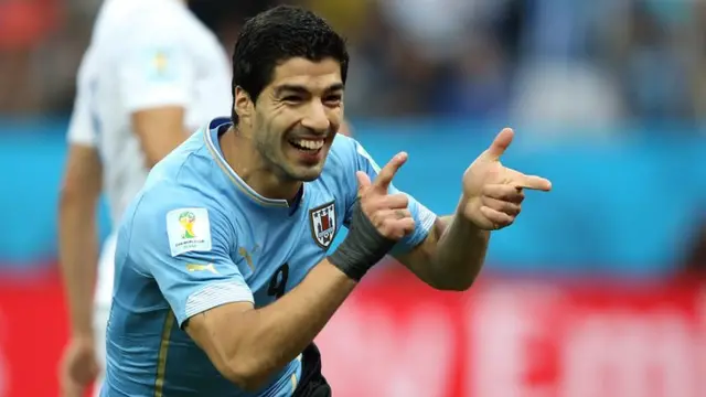 Luis Suarez celebrates his goal against England