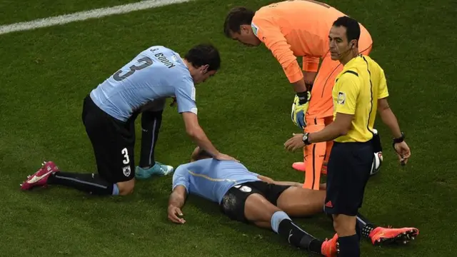 Alvaro Pereira of Uruguay takes a knock to the head