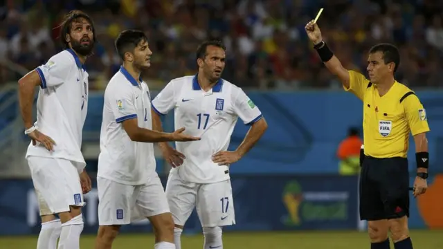 Greece striker Giorgos Samaras is booked against Japan