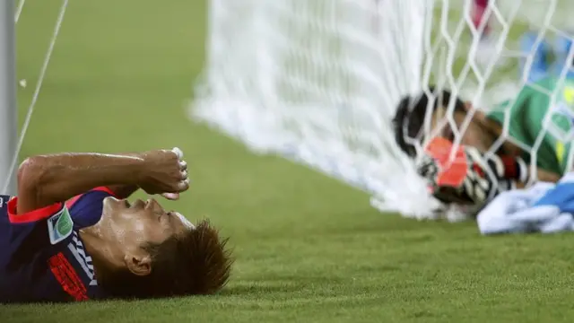 Yoshito Okubo lies on the ground after a terrible miss