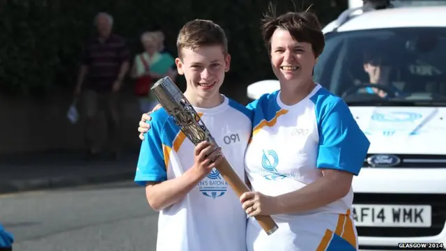 Eileen Granger hands the Glasgow 2014 Queen's Baton