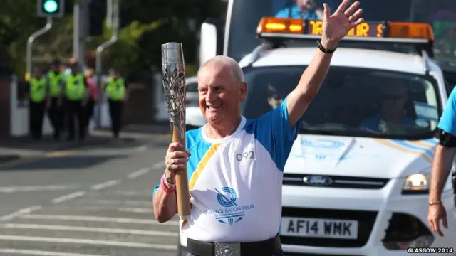 Billy Herd carries the Glasgow 2014 Queen's Baton through Prestwick in South Ayrshire.