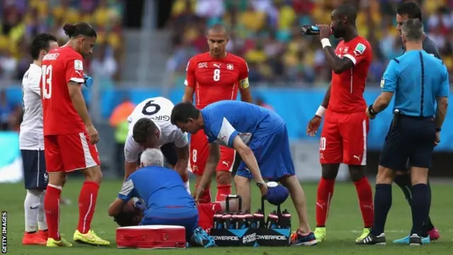 Steve von Bergen of Switzerland receives treatment