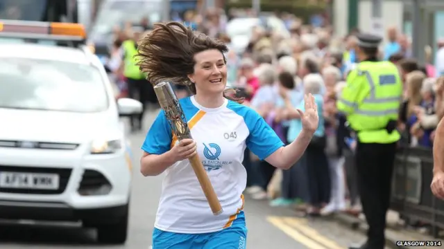 Laura Robertson carries the Glasgow 2014 Queen's Baton through Mauchline in East Ayrshire.