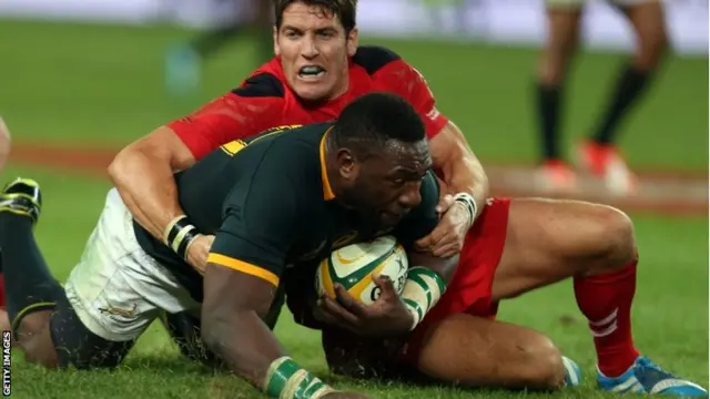 Tendai Mtawarira of South Africa is tackled short of the try line by James Hook in the first Test