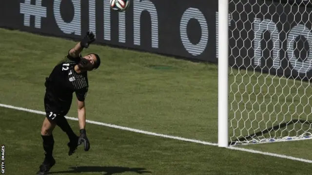 Iran's goalkeeper Alireza Haqiqi makes a save