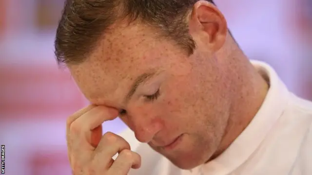 Wayne Rooney faces the media in a press conference after an England training session