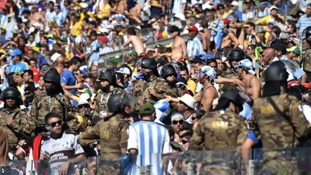 Security personnel position themselves amongst spectators