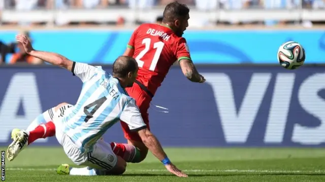 Argentina"s defender Pablo Zabaleta and Iran's forward Ashkan Dejagah vie for the ball