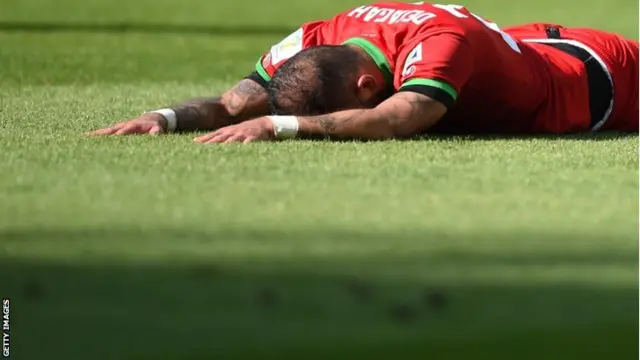 Iran's forward Ashkan Dejagah reacts flat on the floor