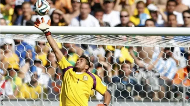 Argentina's goalkeeper Sergio Romero makes a save against a header by Iran's Ashkan Dejagah