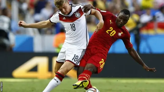 Germany's Toni Kroos fights for the ball with Ghana's Kwadwo Asamoah