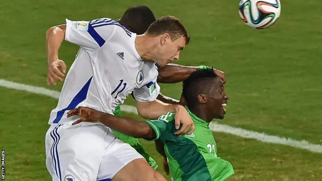 Bosnia-Hercegovina's forward Edin Dzeko heads the ball