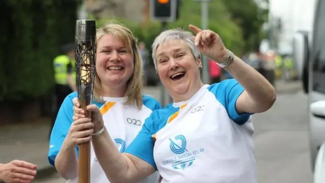 Two women hold the baton on Day 2 of the Queen's Baton Relay in Scotland