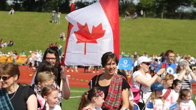 flag bearers with Canadian flag