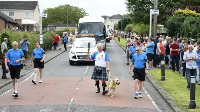 Scott Cunningham with guide dog and baton