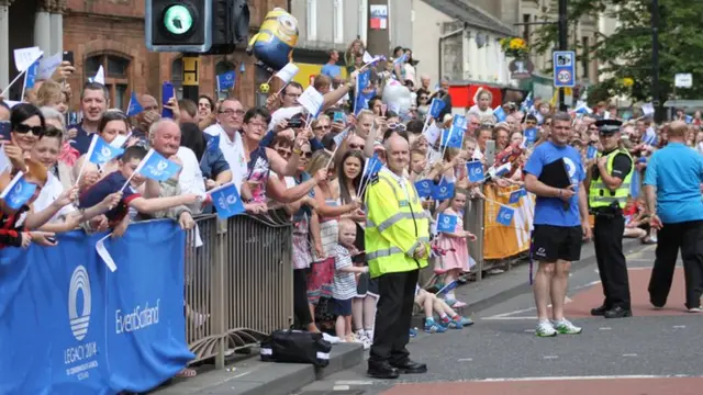 Large crowd all waving flags.